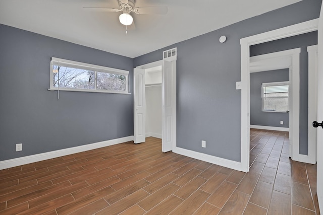 unfurnished bedroom featuring ceiling fan and a closet