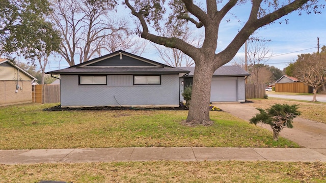 ranch-style house featuring fence, driveway, an attached garage, a front lawn, and brick siding