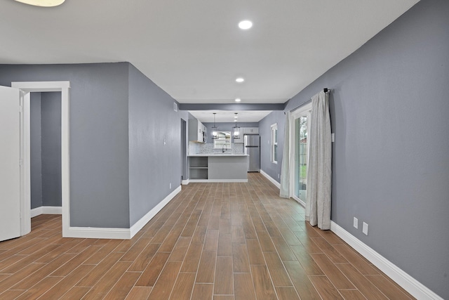 unfurnished living room featuring hardwood / wood-style flooring