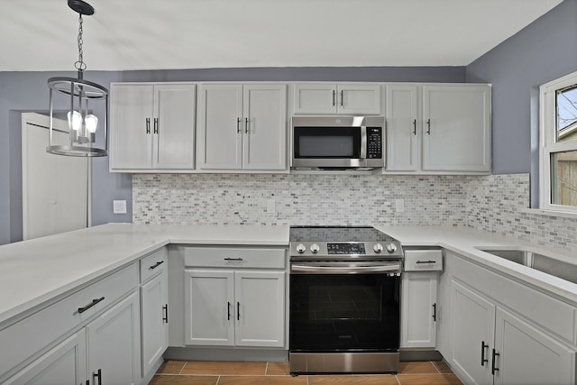 kitchen with white cabinetry, backsplash, decorative light fixtures, and appliances with stainless steel finishes