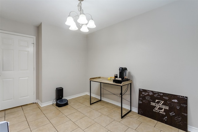 interior space with light tile patterned floors, baseboards, and a notable chandelier