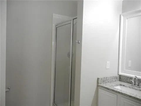 bathroom featuring vanity and walk in shower