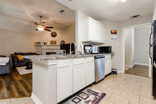 kitchen with stainless steel dishwasher, open floor plan, white cabinetry, black microwave, and a peninsula