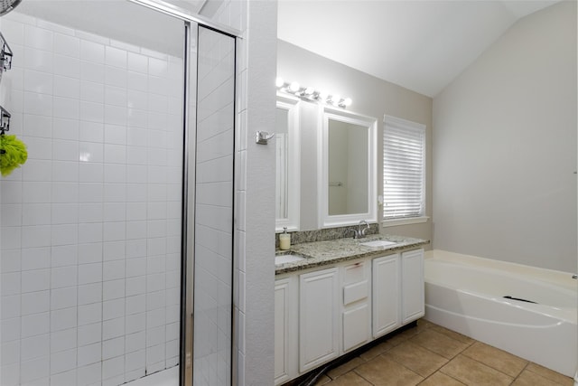 bathroom with a stall shower, tile patterned floors, a sink, vaulted ceiling, and a bath