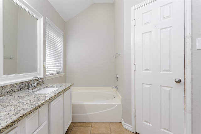 full bath with lofted ceiling, vanity, tile patterned flooring, and a bath