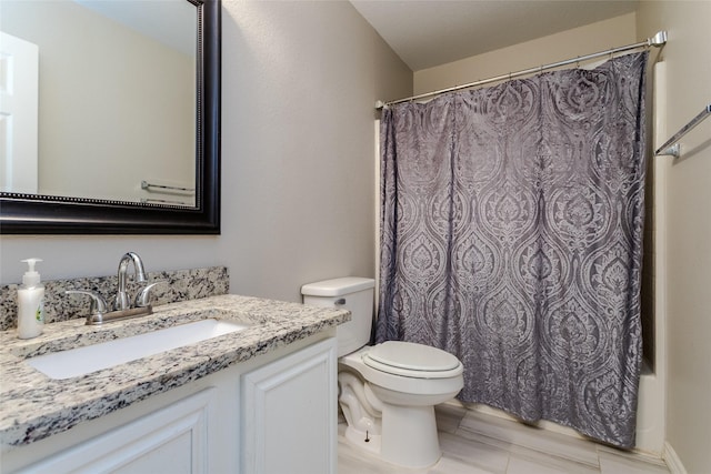 bathroom featuring toilet, shower / bath combo with shower curtain, and vanity