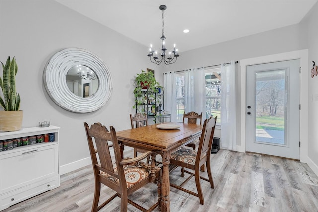 dining room with an inviting chandelier and light hardwood / wood-style floors