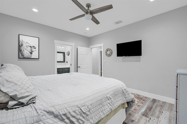 bedroom featuring ceiling fan, connected bathroom, and light wood-type flooring