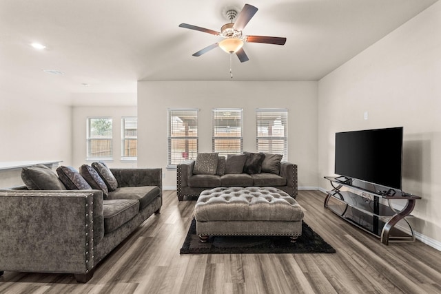 living room featuring wood-type flooring and ceiling fan