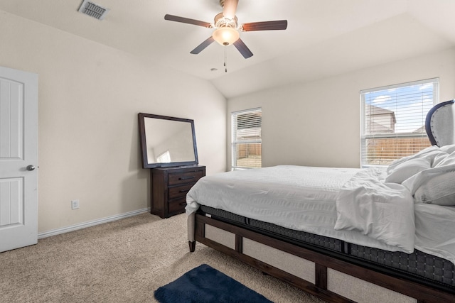 carpeted bedroom with vaulted ceiling and ceiling fan