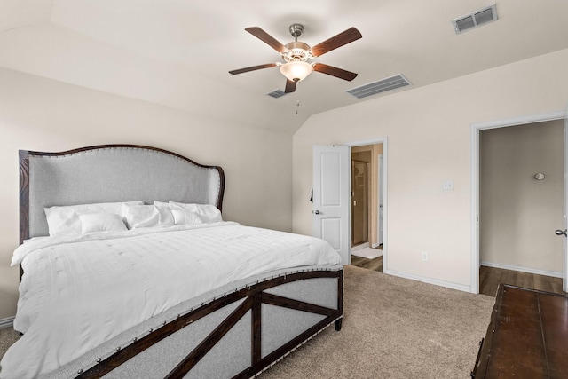 bedroom with vaulted ceiling, ceiling fan, and dark colored carpet