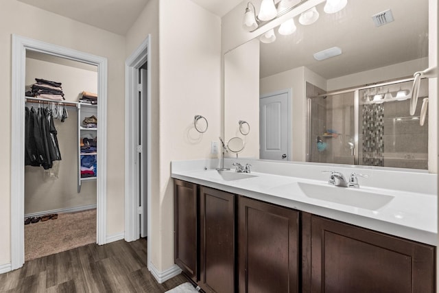 bathroom featuring vanity, an enclosed shower, and hardwood / wood-style floors