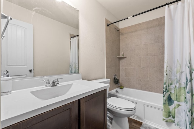 full bathroom with hardwood / wood-style flooring, shower / bath combo, vanity, and toilet