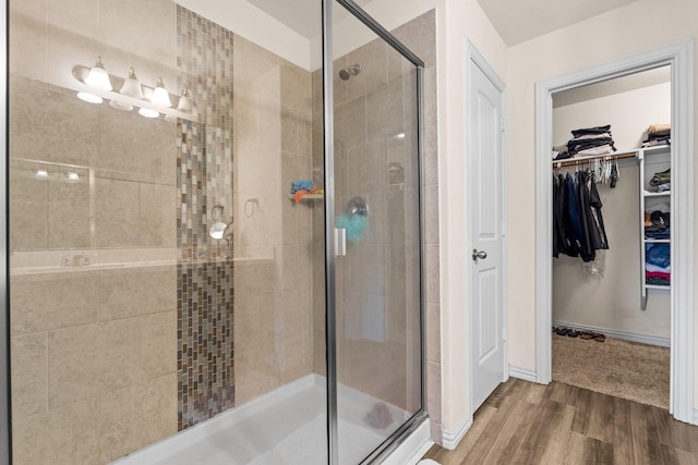 bathroom with wood-type flooring and walk in shower