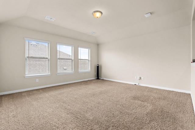 unfurnished room with vaulted ceiling and carpet floors