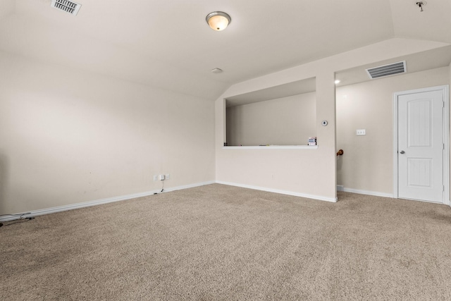 spare room with vaulted ceiling and carpet