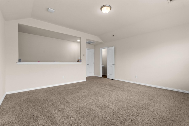 spare room with lofted ceiling and carpet floors