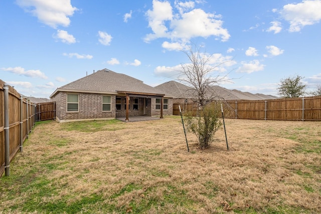 back of property featuring a patio area and a lawn