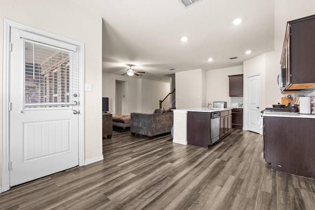 kitchen featuring dark hardwood / wood-style floors, a center island with sink, and dark brown cabinetry