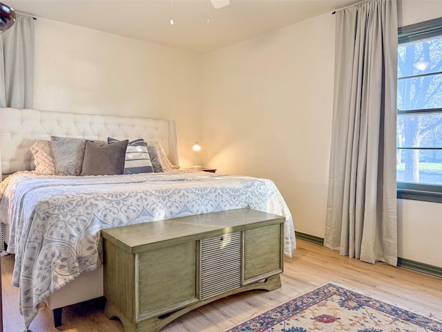 bedroom featuring multiple windows and light hardwood / wood-style floors