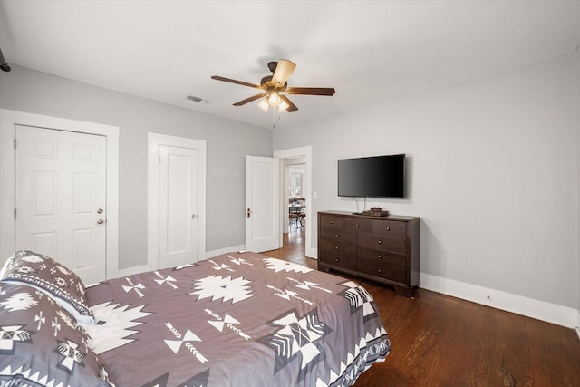 bedroom with dark wood-type flooring, a closet, and ceiling fan