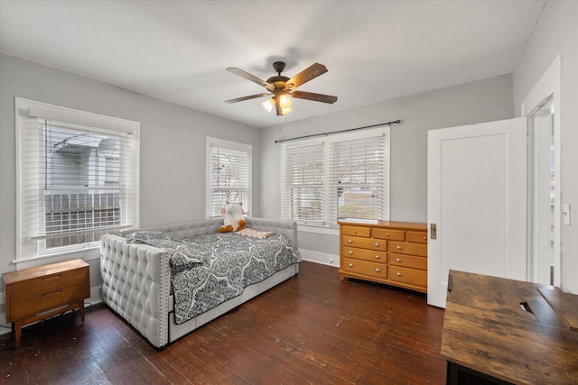 bedroom with dark wood-type flooring and ceiling fan