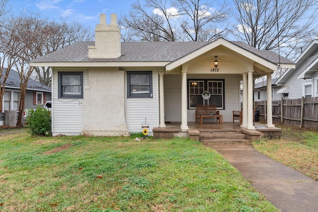 bungalow-style home with a front lawn and a porch