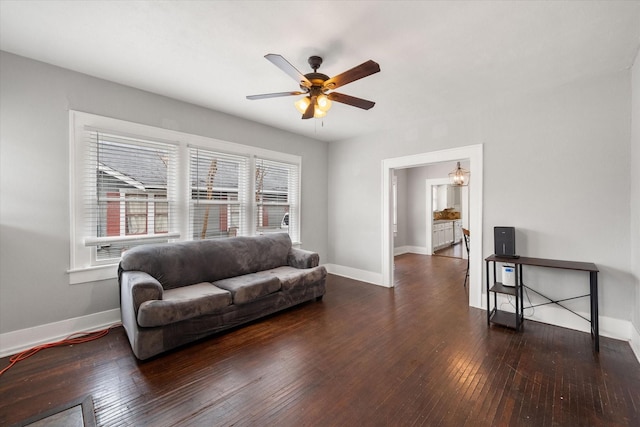 living room featuring dark hardwood / wood-style flooring and ceiling fan