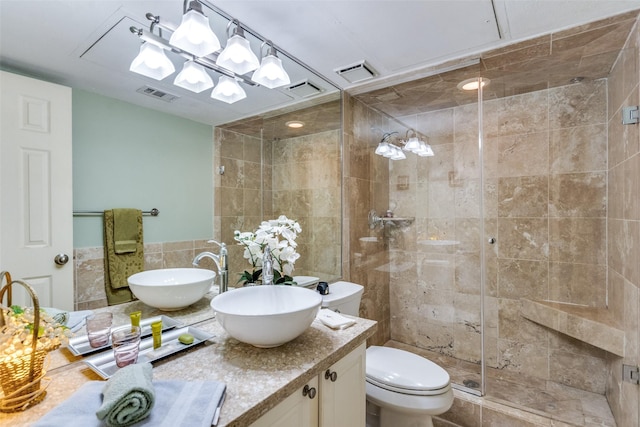 bathroom featuring vanity, toilet, tile walls, and walk in shower