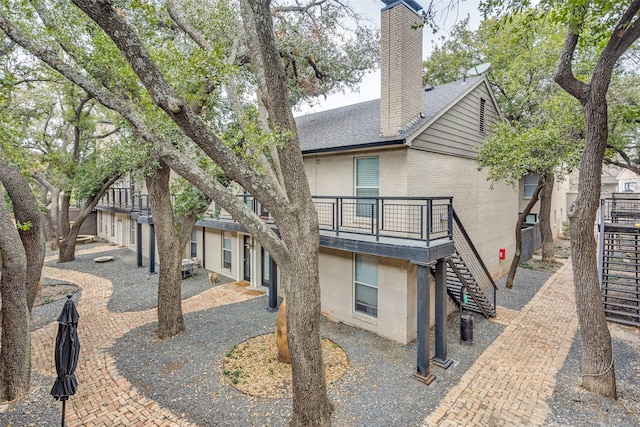 back of house with a balcony