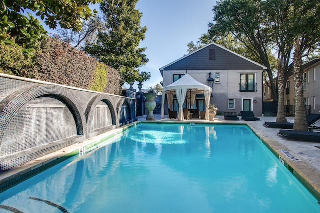 view of pool with a patio and pool water feature