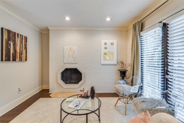 living room with a fireplace, crown molding, and wood-type flooring