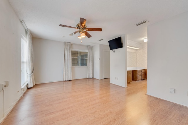 empty room featuring ceiling fan and light wood-type flooring