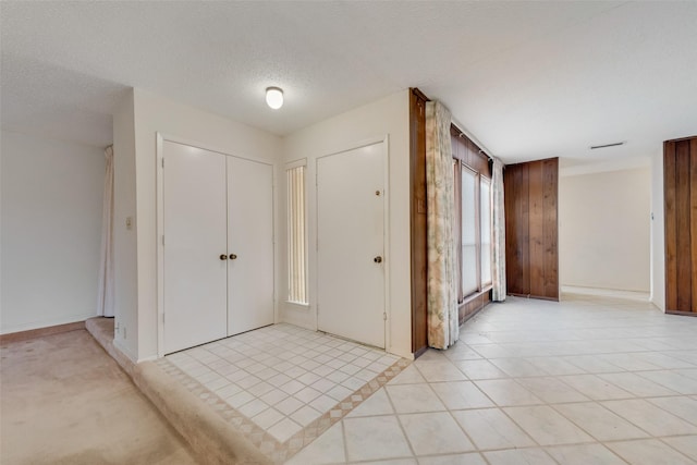 tiled entrance foyer with a textured ceiling