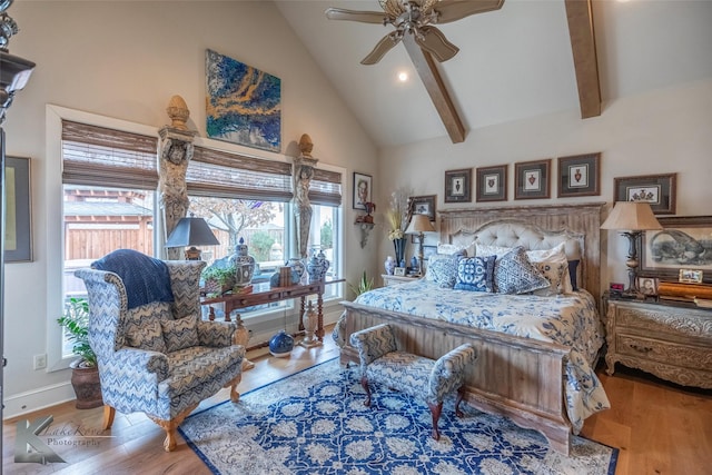 bedroom with hardwood / wood-style flooring, beam ceiling, and high vaulted ceiling