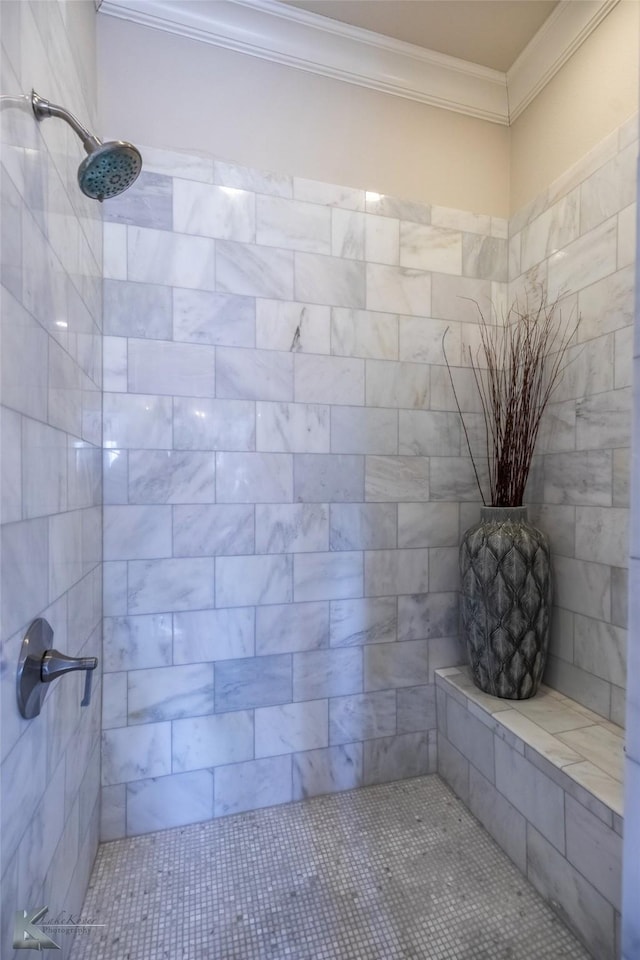 bathroom with crown molding and tiled shower