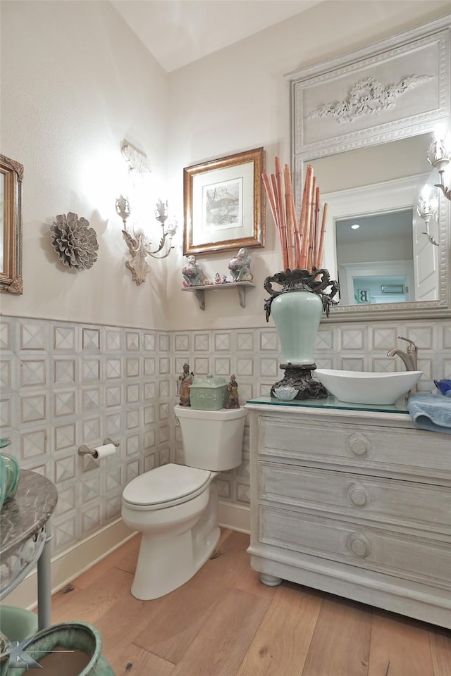 bathroom featuring vanity, wood-type flooring, and toilet