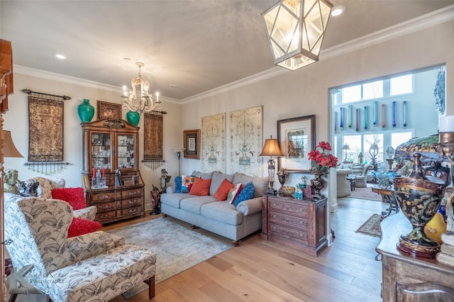 living room featuring crown molding, light hardwood / wood-style floors, and a chandelier