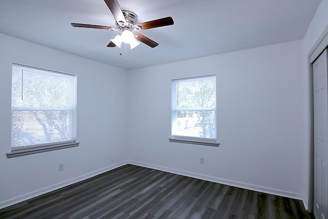 spare room with ceiling fan and dark wood-type flooring