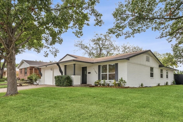 single story home with a garage and a front lawn