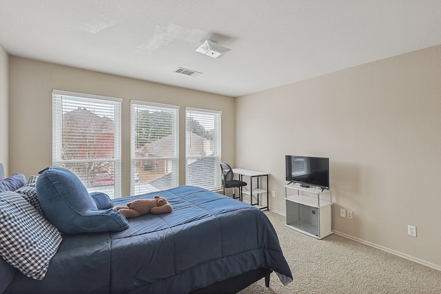 carpeted bedroom featuring a textured ceiling