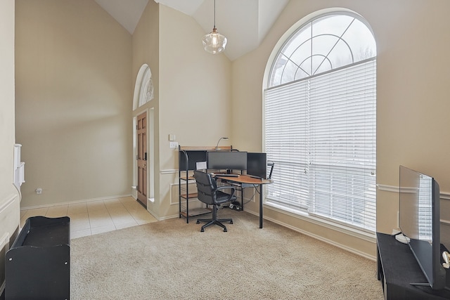 home office featuring light carpet and high vaulted ceiling