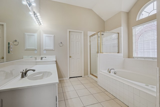 bathroom featuring vaulted ceiling, separate shower and tub, tile patterned floors, and vanity