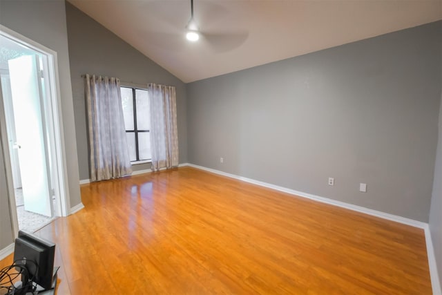 spare room featuring ceiling fan, wood-type flooring, and lofted ceiling