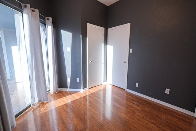 empty room with hardwood / wood-style floors