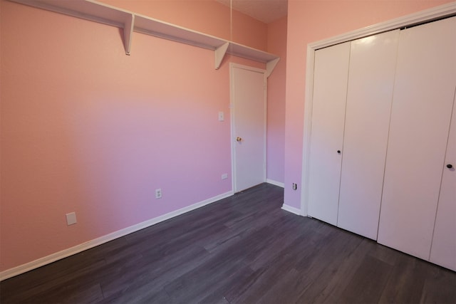 unfurnished bedroom with a closet and dark hardwood / wood-style floors