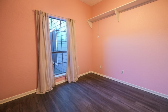 empty room featuring dark wood-type flooring