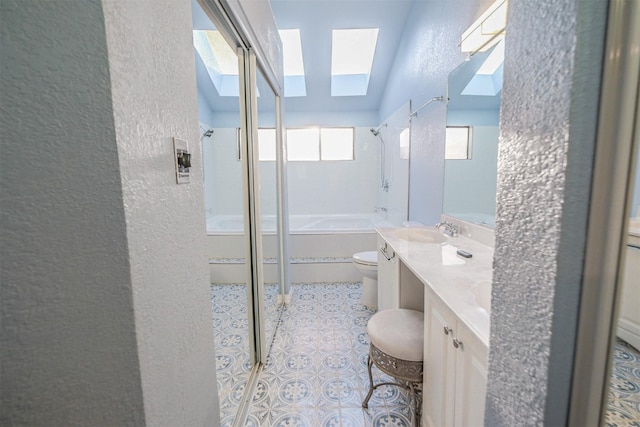 full bathroom with vanity, toilet, a skylight, and plus walk in shower