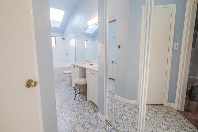 full bathroom featuring tile patterned flooring, a skylight, vanity, shower / washtub combination, and toilet