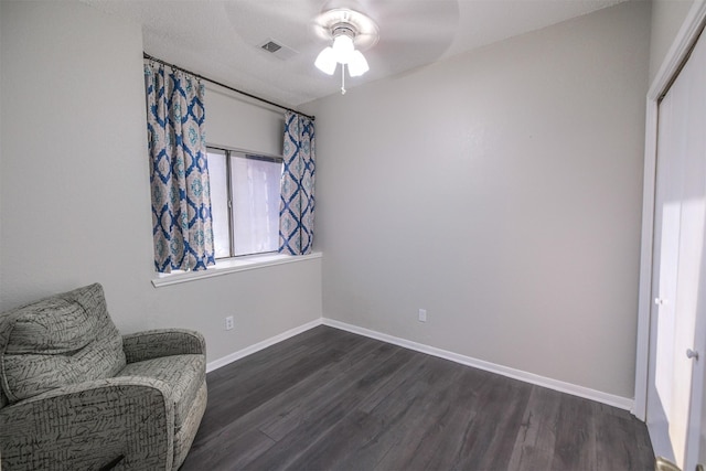 sitting room with ceiling fan and dark hardwood / wood-style floors